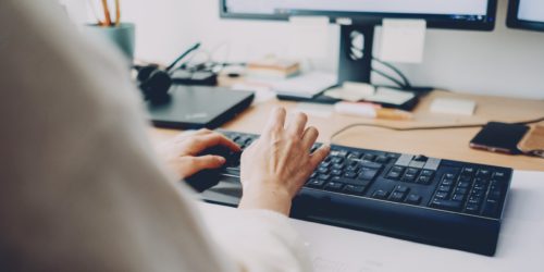 person on computer focused on lead management