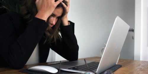 woman using laptop and frustrated with mismanaged lead data