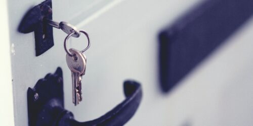 Key to unlock a door symbolizing insider sales process secrets